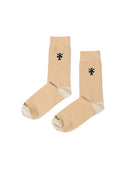 Pair of beige socks with a black logo on a white background